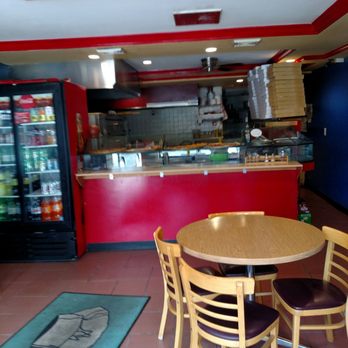 2 Brothers Pizzeria & Restaurant - a table and chairs in a restaurant - Pizza Near Me - Ewing Township, New Jersey
