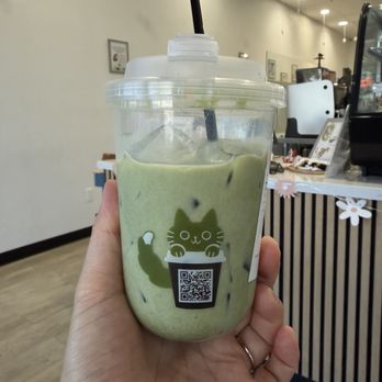 Fluffy Tail Cafe - Iced matcha latte with oatmilk (sips taken) - Coffee & Tea Near Me - Tustin, California