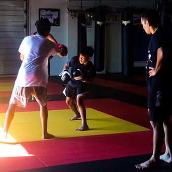 Train 4 Life - Sifu Sonny watches Kainoa doing some pad work back at the Main St location. - Boxing Near Me - Fairfield, California Train 4 Life - Sifu Sonny watches Kainoa doing some pad work back at the Main St location. - Boxing Near Me - Fairfield, California