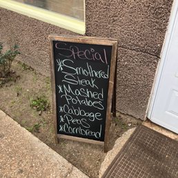 a chalkboard sign outside of a restaurant a chalkboard sign outside of a restaurant