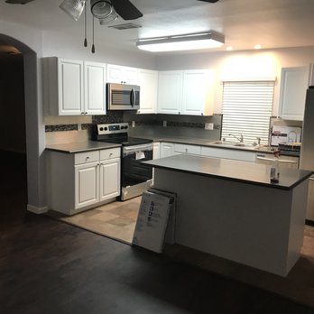 Lansden Construction - a kitchen with white cabinets and stainless steel appliances - General Contractors Near Me Lansden Construction - a kitchen with white cabinets and stainless steel appliances - General Contractors Near Me