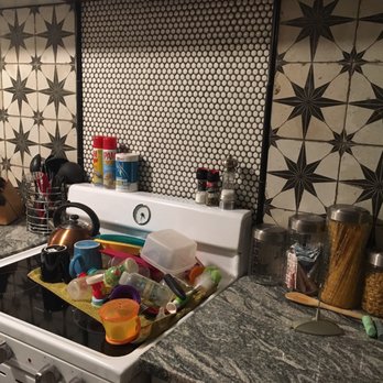 The Tile Shop - a kitchen with a stove and counter top - Tiling Near Me - Haltom City, Texas