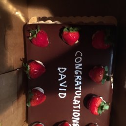 a chocolate covered cake with strawberries a chocolate covered cake with strawberries