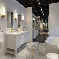 Kohler Signature Store by GROF USA - Purist gold finishes with Kiruna marble look tiles by Vives