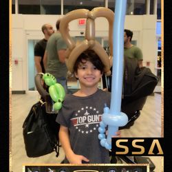 ICON Park - There are Super cool balloon artists making balloon outfits in various places around the world the park this kid had a pirate sword and bird