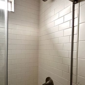 Matt Construction - Tiling between shower head and controls was broken (to remove old shower) and retiled to match existing tile. - General Contractors Near Me - Medford, Massachusetts