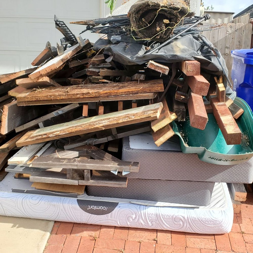 King size mattress and box springs, old playground set, construction debris.