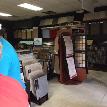 House Of Tiles - a man and woman looking at tile samples - Flooring Near Me - Bunnell, Florida House Of Tiles - a man and woman looking at tile samples - Flooring Near Me - Bunnell, Florida