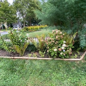 Michaels Lawn Care - a flower bed in front of a house - Lawn Services Near Me Michaels Lawn Care - a flower bed in front of a house - Lawn Services Near Me