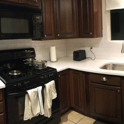 Thompson Granite & Stone - New white quartz countertops and stainless steel undercount sink installed by Dwight's team