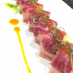 New Peking Palace - Kobe Beef Maki(Roll). Scallop,crab meat,Frying fish roe,eel and avocado, topped with seared Kobe beef, scallions in chef's special sauce