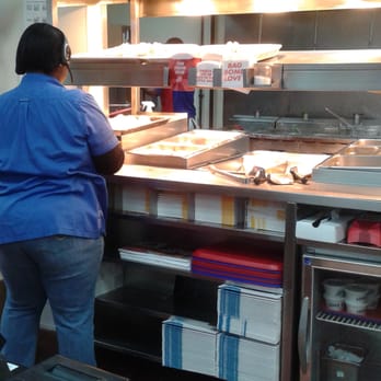 Church's Chicken - a woman preparing food in a kitchen - Fast Food Near Me - Tifton, Georgia