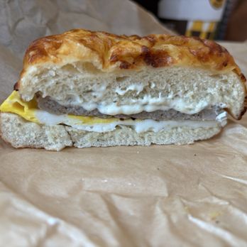 Einstein Bros. Bagels - Six cheese bagel, sausage patty, egg, and onion chive smear. - Breakfast & Brunch Near Me - Georgetown, Texas Einstein Bros. Bagels - Six cheese bagel, sausage patty, egg, and onion chive smear. - Breakfast & Brunch Near Me - Georgetown, Texas