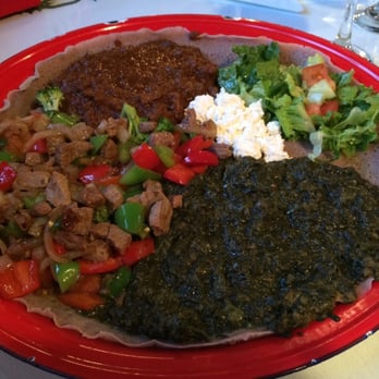 Langano Skies - Special beef tibs (on left), lamb, salad, fresh cheese and spinach. - Ethiopian Near Me - Edmonton, Alberta Langano Skies - Special beef tibs (on left), lamb, salad, fresh cheese and spinach. - Ethiopian Near Me - Edmonton, Alberta