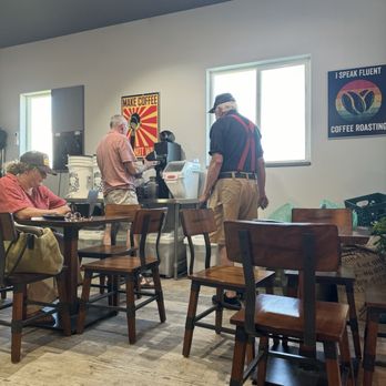 Wydaho Roasters Coffee House - Owner grinding coffee with a regular customer - Coffee & Tea Near Me - Driggs, Idaho Wydaho Roasters Coffee House - Owner grinding coffee with a regular customer - Coffee & Tea Near Me - Driggs, Idaho