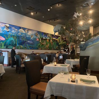 Everglades Restaurant - a dining room with tables and chairs - Seafood Near Me - Orlando, Florida Everglades Restaurant - a dining room with tables and chairs - Seafood Near Me - Orlando, Florida