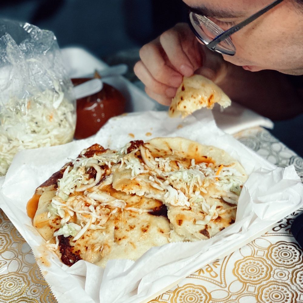 Estela's Restaurant - a man eating pizza - Salvadoran Near Me - Pacoima, California