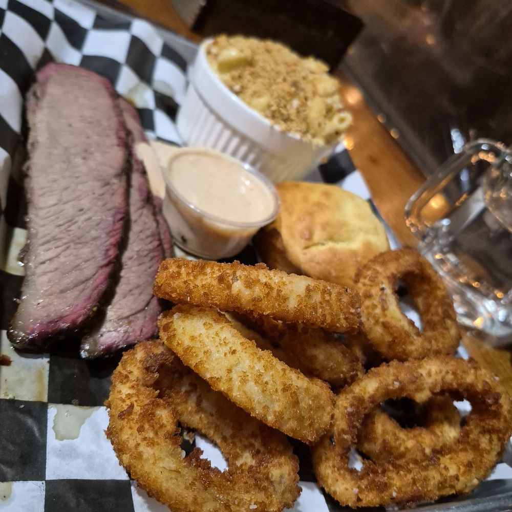 This is the brisket and onion rings with the mack and cheese This is the brisket and onion rings with the mack and cheese