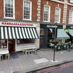 Pizza Pilgrims - View from the tour bus of the store front. Green awnings of course.