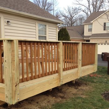 The Best Guys - a wooden deck with railings - Landscaping Near Me The Best Guys - a wooden deck with railings - Landscaping Near Me