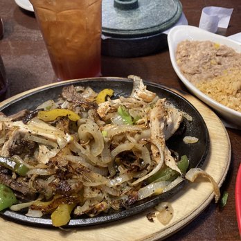 Rock Island Grill - Steak and Chicken Fajitas. Rice/beans. Not pictured: sour cream, guac and cilantro, onions and jalapeños. 6 warm tortillas - American Near Me - Chickasha, Oklahoma