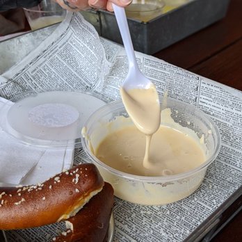 Prospect Drafthouse - a person dipping a pretzel into a bowl - Bars Near Me - Mineral, Virginia Prospect Drafthouse - a person dipping a pretzel into a bowl - Bars Near Me - Mineral, Virginia