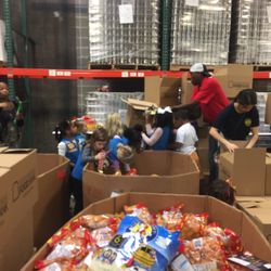 Greater Baton Rouge Food Bank - Girl Scout Troop #10664 sorting through candy to help at the Greater Baton Rouge Food Bank!