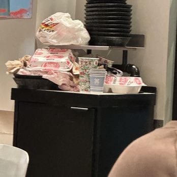 Raising Cane's Chicken Fingers - Trash is over flowing to the ground. - Fast Food Near Me - Buford, Georgia