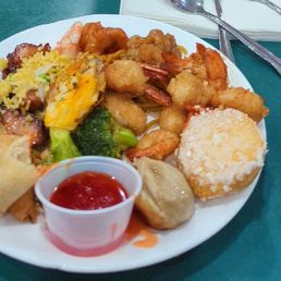 Plate of food items. The beignet was the best thing on the plate.