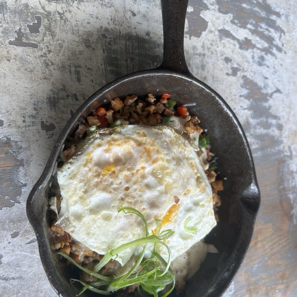 Dish Society - Sausage & Potato skillet topped with fried eggs. - New American Near Me - Houston, Texas