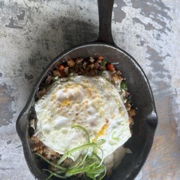 Sausage & Potato skillet topped with fried eggs.