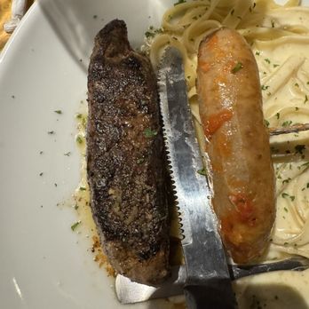 Olive Garden Italian Restaurant - 6oz sirloin steak next to an Italian sausage from another plate - Italian Near Me - Yuma, Arizona Olive Garden Italian Restaurant - 6oz sirloin steak next to an Italian sausage from another plate - Italian Near Me - Yuma, Arizona