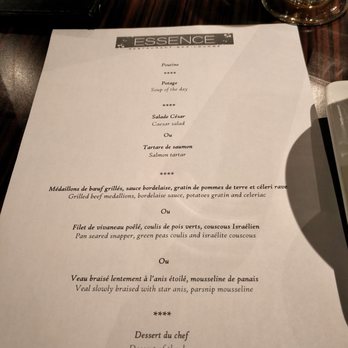 Essence - a table setting with a menu and a candle - Lounges Near Me - Montreal, Quebec