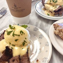 Toffee - Ice cream with herbs on a plate, a slice of cake with icing, and a plate of beef with sauce, alongside a coffee cup at Gypsy Kitchen.
