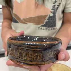 Muddy's Studio - Holding one of dog bowl she made