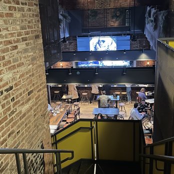 Trata - a view of a restaurant from the top of a flight of stairs - New American Near Me - Rochester, New York