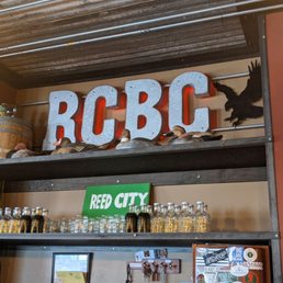 a shelf with bottles and a sign
