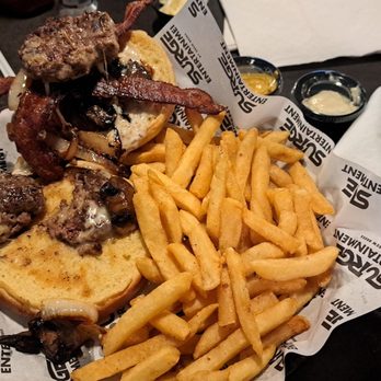 Surge Entertainment by Drew Brees - The Brees Experience Burger, but missing the menu described two brisket-chuck quarter pound patties. - Arcades Near Me - Mobile, Alabama Surge Entertainment by Drew Brees - The Brees Experience Burger, but missing the menu described two brisket-chuck quarter pound patties. - Arcades Near Me - Mobile, Alabama
