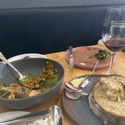 Wine, trout, and sour dough bread. SO good. We love this place. Wine, trout, and sour dough bread. SO good. We love this place.