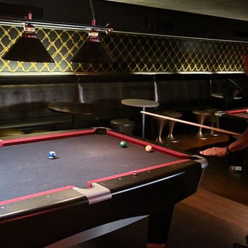 Stardust Lounge - a pool table with a pool ball on it - Lounges Near Me - Orlando, Florida