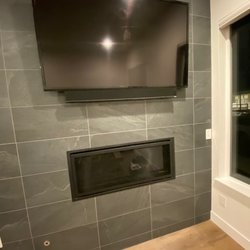 Get Smart Home - 65" TV mounted above fire place on stone tile with concealed wires