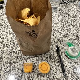 Chips and queso to go. This is literally all the queso it came with.  Pen & tape for scale.