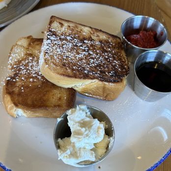 Bluebird Kitchen - French toast with fixings on the side - French toast served with whipped butter, syrup, and fruit preserves on a white plate at a restaurant. - Cocktail Bars Near Me - Bellmore, New York