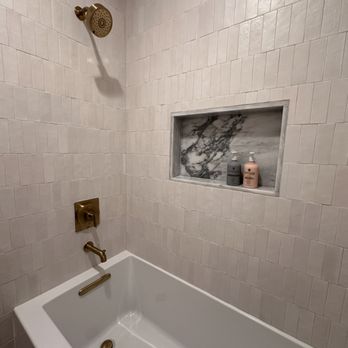 Momentum Tile & Stone - a bathtub in a bathroom - Flooring Near Me Momentum Tile & Stone - a bathtub in a bathroom - Flooring Near Me