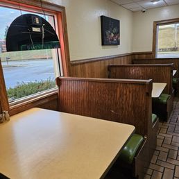 Some booths near a window of the restaurant.