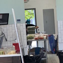 Staff eating out of the trays in his barehand.