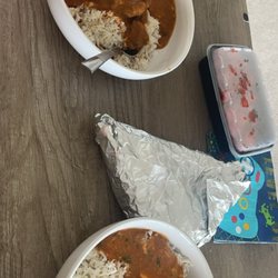 Zyqa Resturant - Rogan josh (left) and paneer shahi korma (right) in the foil is two orders of garlic naan and plastic container has the chicken 65