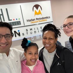 Behl Orthodontics - Dr Behl and smiling family