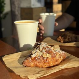 Almond croissant and latte Almond croissant and latte