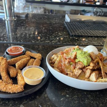 Mainstream Bar & Grill - Happy hour buy one get one free. Left (Calamari strips) Right (Nachos with chicken) - Sports Bars Near Me - Carlsbad, California